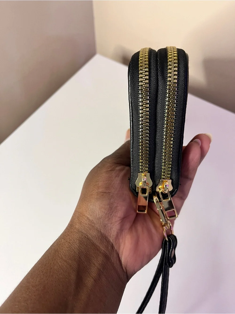 SUGU Black Leather Wristlet Clutch with Gold Emblem
